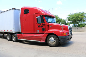 Red Semi on Concrete for Delivery and Shipments